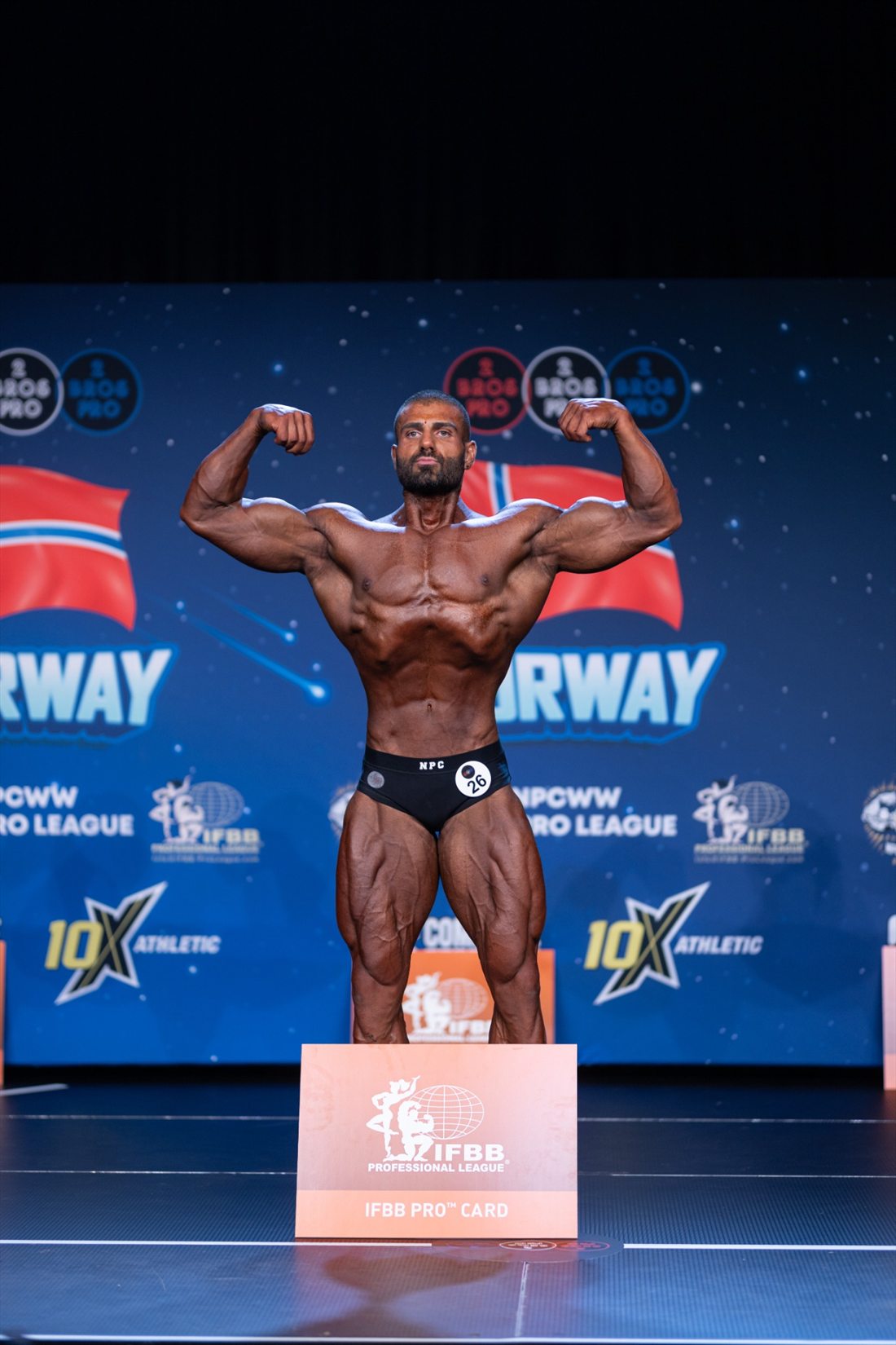 Michel Maalouf on stage after earning his IFBB Pro card